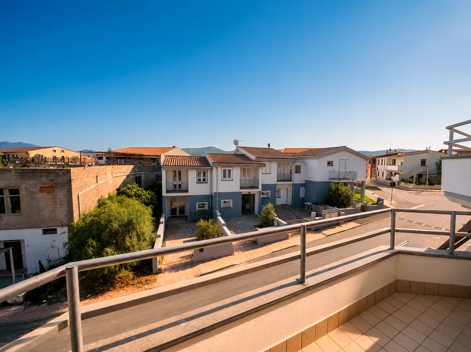 Spacious tiled front terrace with stainless railing looking towards the hills behind Valledoria