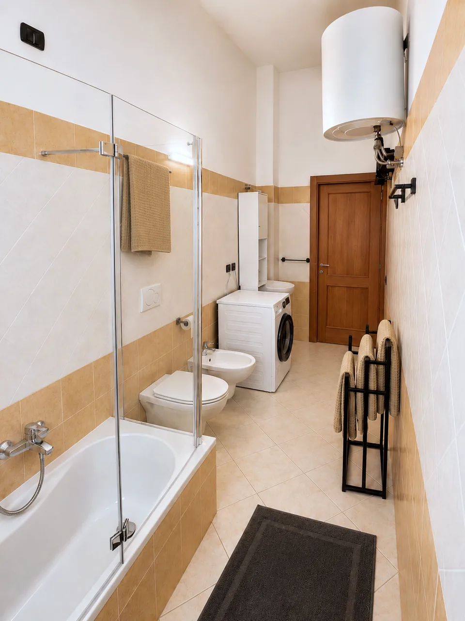 Bathroom bathtub with glass shower screen, towel rail and freestanding towel rack