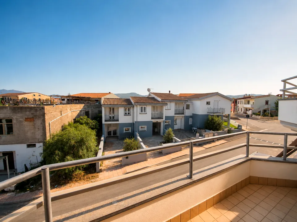 View from the rear balcony over red-tiled rooftops to the hills of Valledoria