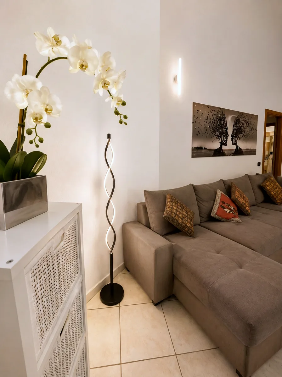 Lounge detail with orchid, sculptural floor lamp and woven storage unit