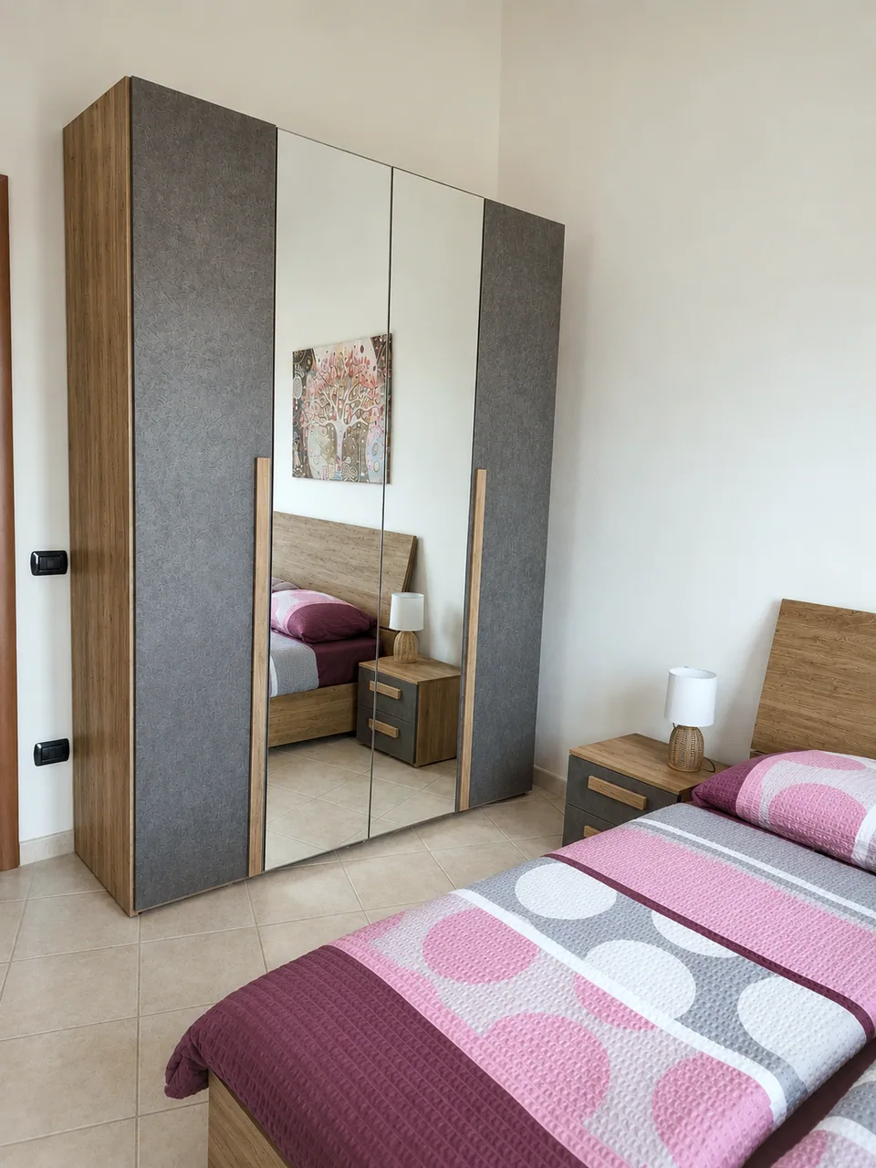 Master bedroom mirrored four-door wardrobe with ample storage