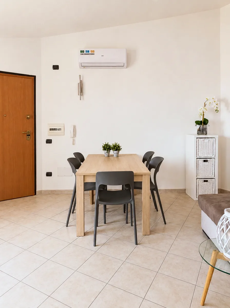 Oak dining table for six with grey chairs beside the private entrance