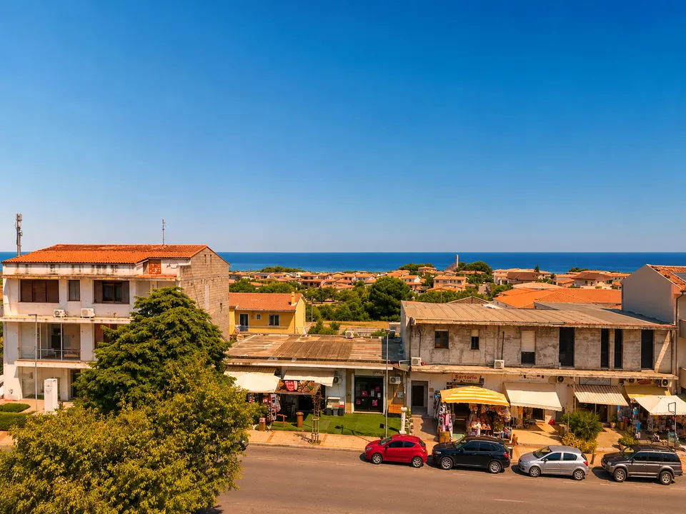 Front terrace outlook over the village shops of Valledoria with the sea on the horizon