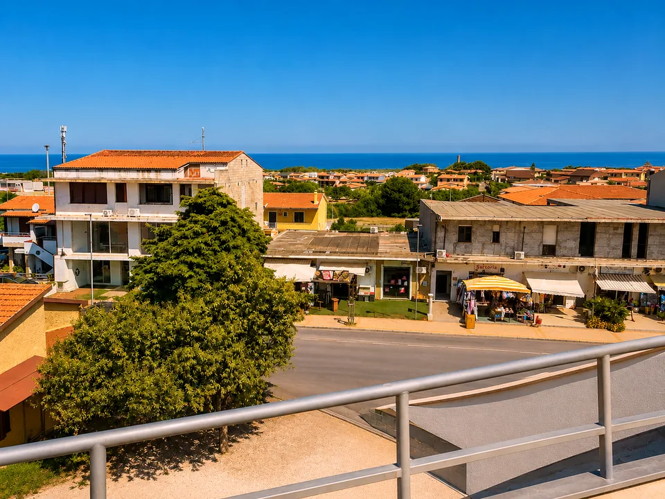 View from the front terrace across terracotta rooftops and pine trees to the blue Mediterranean sea