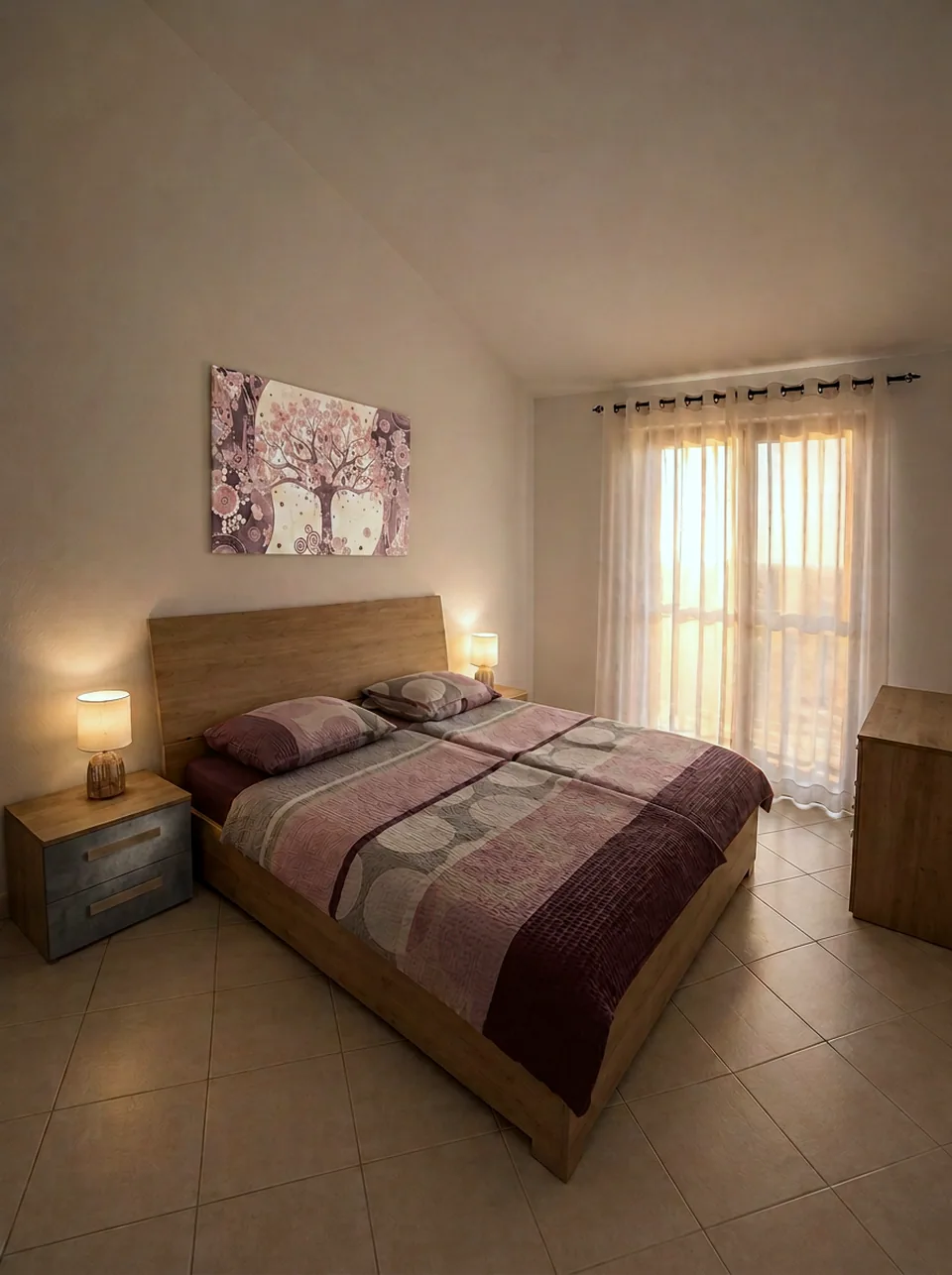 Master bedroom at sunset with warm bedside lamplight